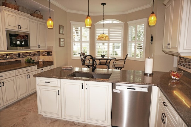 kitchen with stainless steel appliances, sink, dark stone counters, hanging light fixtures, and crown molding