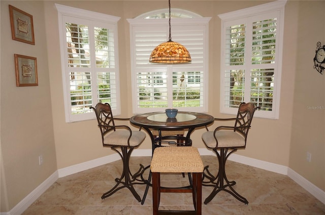 dining space featuring baseboards