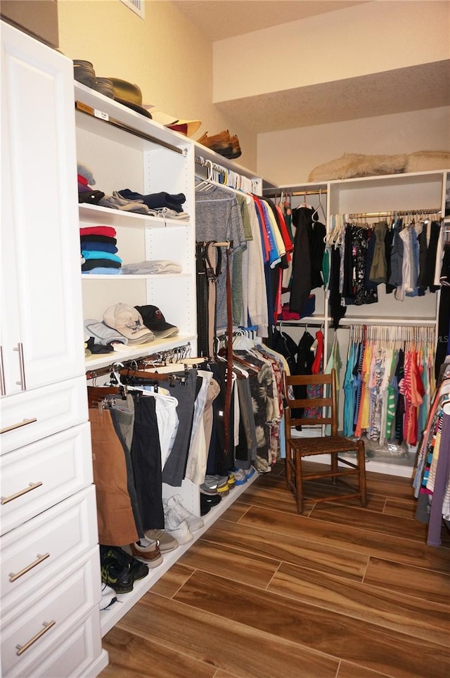 walk in closet with hardwood / wood-style flooring