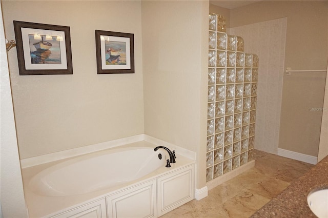 bathroom featuring walk in shower and a bath