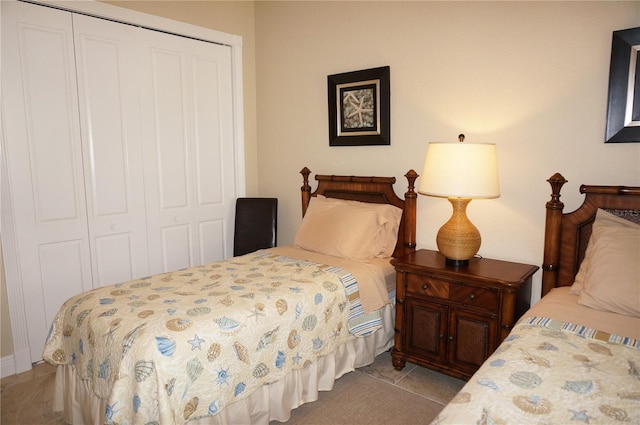 tiled bedroom with a closet