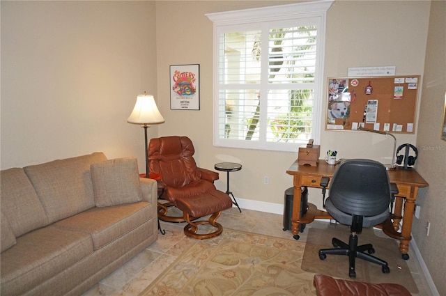 office space featuring plenty of natural light and baseboards