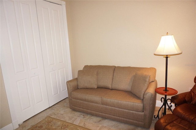 living area featuring baseboards