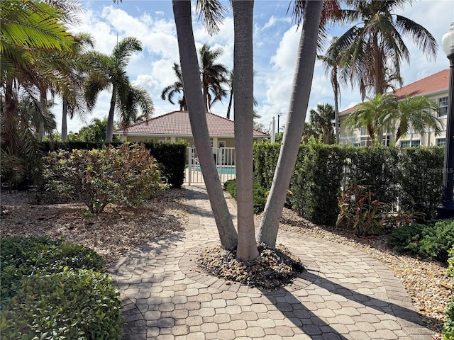 view of front of home with fence and a tile roof