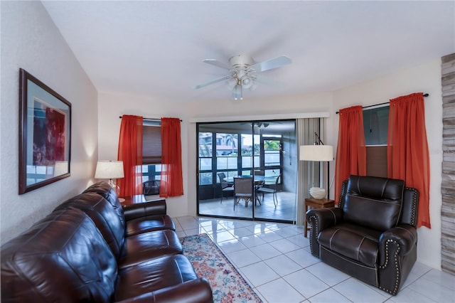 living room with ceiling fan and light tile patterned floors