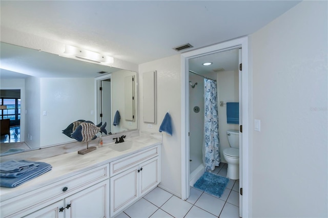 bathroom featuring toilet, a shower with curtain, vanity, and tile patterned floors