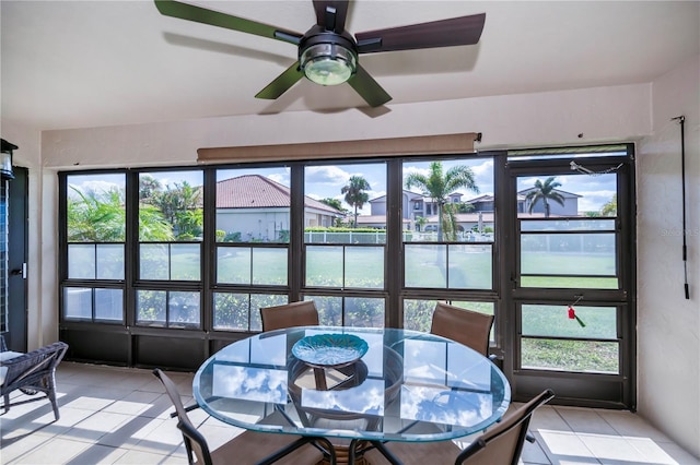 sunroom featuring ceiling fan and a healthy amount of sunlight