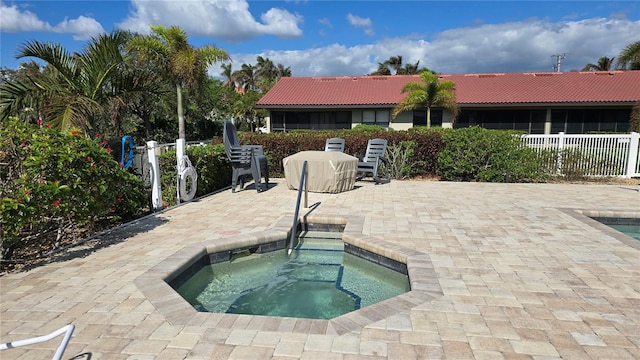 view of pool with an in ground hot tub