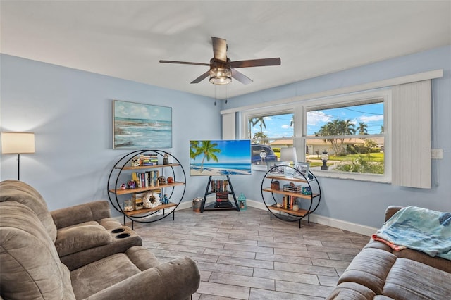 living room with light hardwood / wood-style floors and ceiling fan