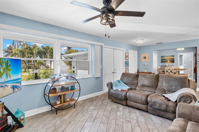 living room featuring light wood-type flooring and ceiling fan