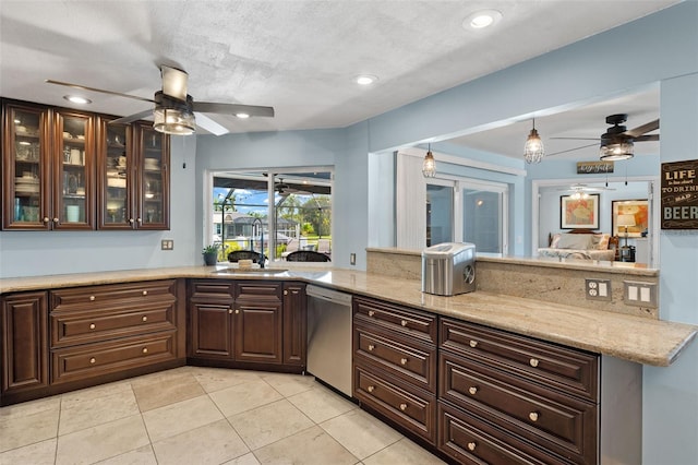 kitchen with dark brown cabinetry, sink, light stone countertops, a textured ceiling, and stainless steel dishwasher