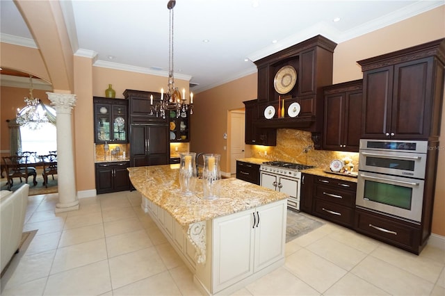 kitchen featuring dark brown cabinets, decorative columns, a kitchen island, and stainless steel appliances