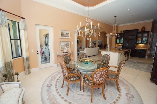 3507 Terin Ct, Punta Gorda, FL 33950 - dining room featuring a chandelier, arched walkways, crown molding, ornate columns, and light tile patterned floors
