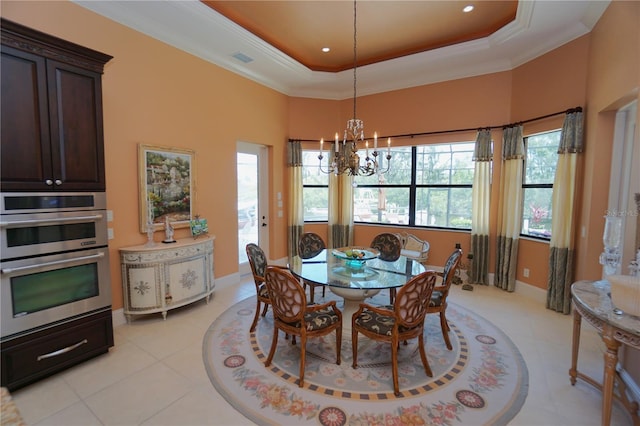 dining room featuring a raised ceiling, light tile patterned floors, crown molding, and a chandelier