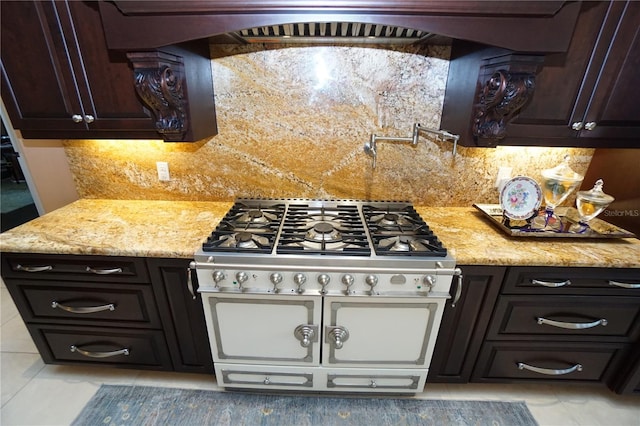 kitchen with dark brown cabinets, tasteful backsplash, and light stone counters