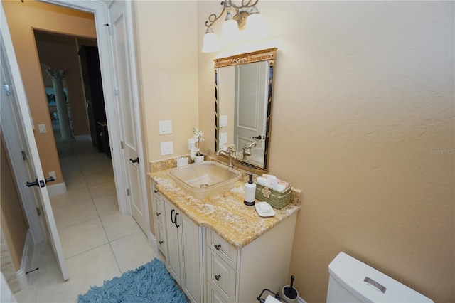 bathroom featuring tile patterned flooring, vanity, and toilet