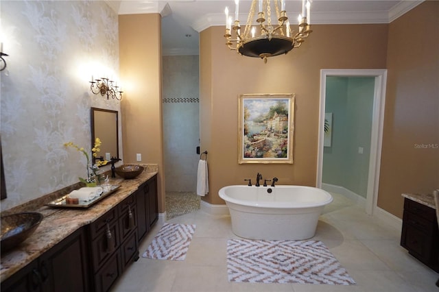 bathroom with a bathing tub, vanity, ornamental molding, and a notable chandelier