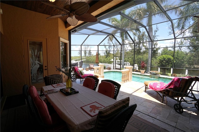 view of patio featuring ceiling fan and a lanai