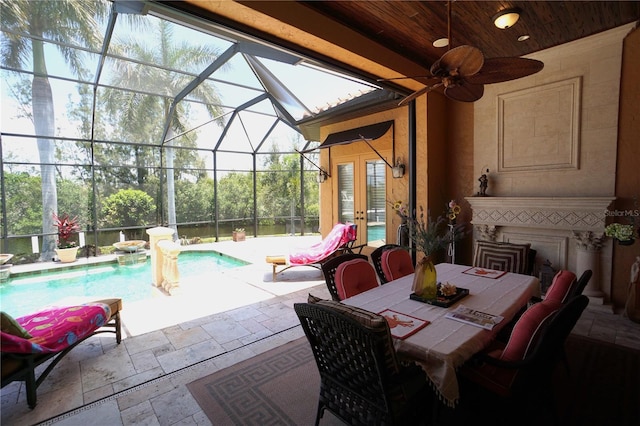 view of patio / terrace with glass enclosure, ceiling fan, and french doors