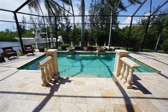 view of pool featuring glass enclosure and a patio area