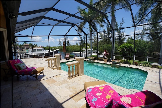 view of pool with a patio area and a lanai