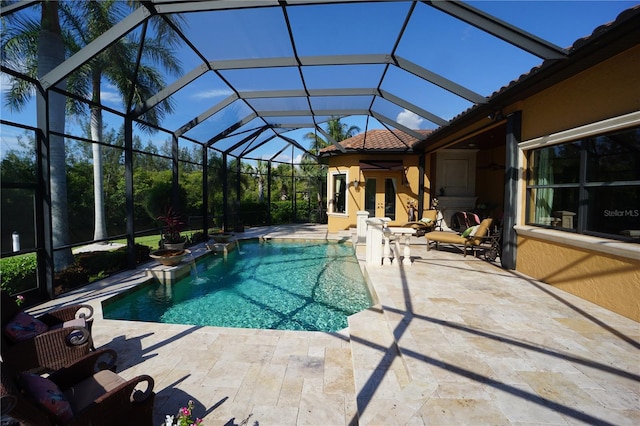 view of pool with a lanai and a patio