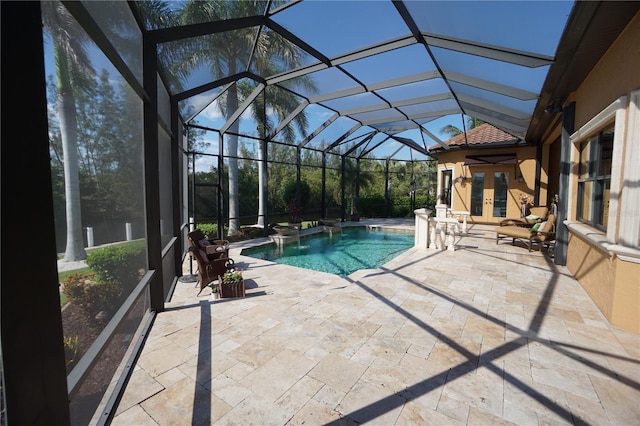 view of swimming pool featuring glass enclosure, a patio area, and french doors