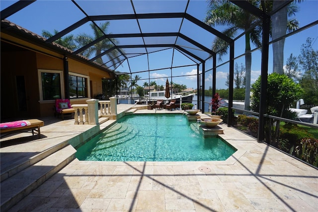 view of pool with pool water feature, a patio area, and a lanai