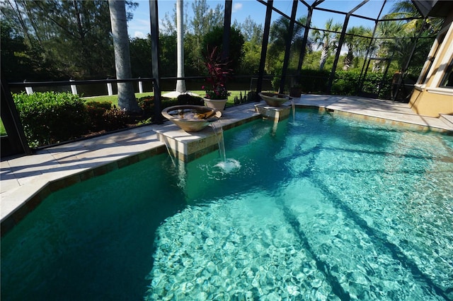 view of swimming pool featuring pool water feature and a lanai