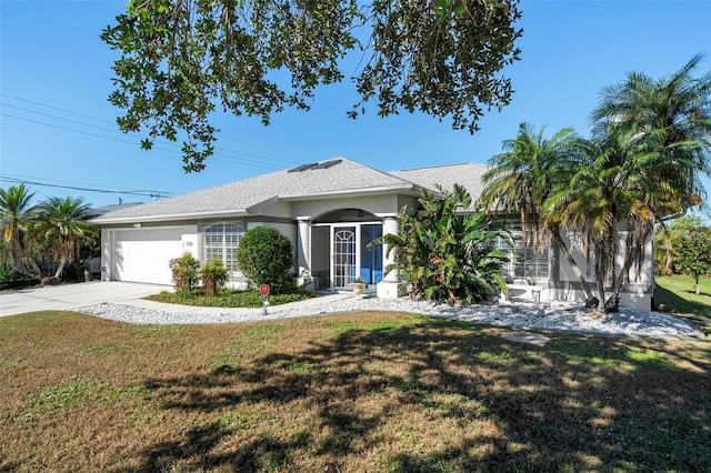 ranch-style house featuring a front yard and a garage