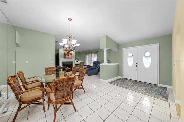 dining room featuring a notable chandelier and light tile patterned flooring