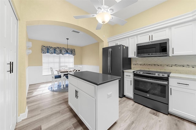 kitchen featuring white cabinets, appliances with stainless steel finishes, and light hardwood / wood-style flooring