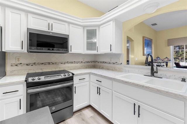 kitchen featuring sink, white cabinets, and appliances with stainless steel finishes