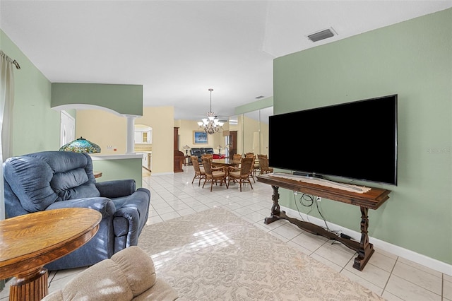 living room with light tile patterned floors and a chandelier