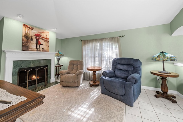 interior space featuring a tile fireplace and light tile patterned flooring