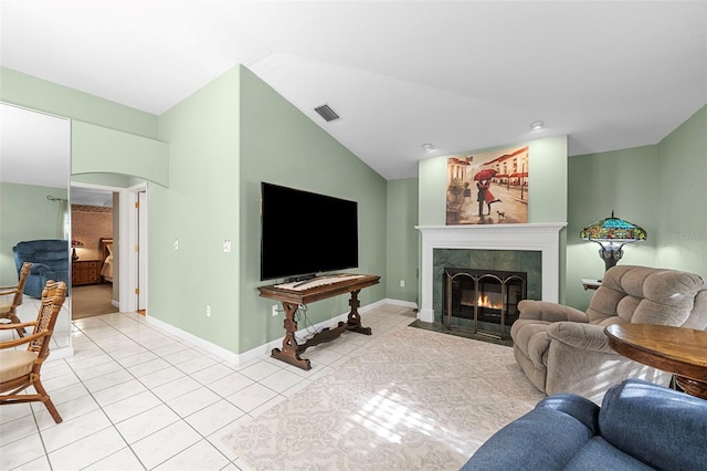 living room with light tile patterned floors, a fireplace, and vaulted ceiling