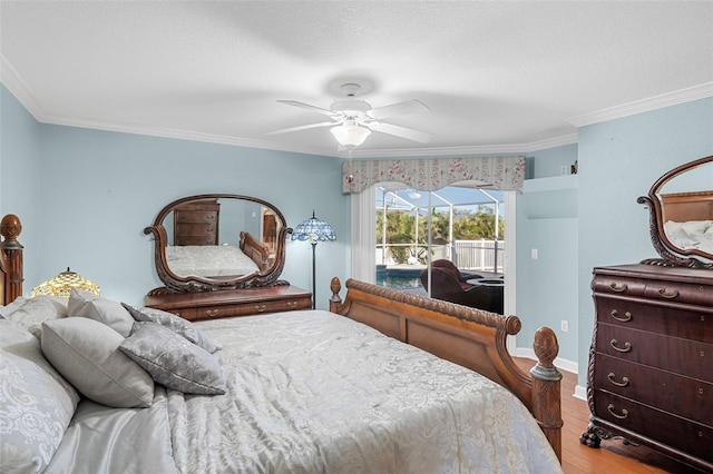 bedroom with ceiling fan, access to exterior, wood-type flooring, and ornamental molding