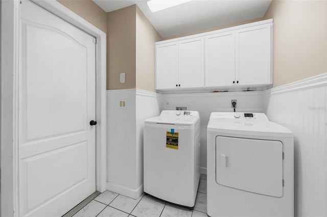 washroom with cabinets and washing machine and clothes dryer