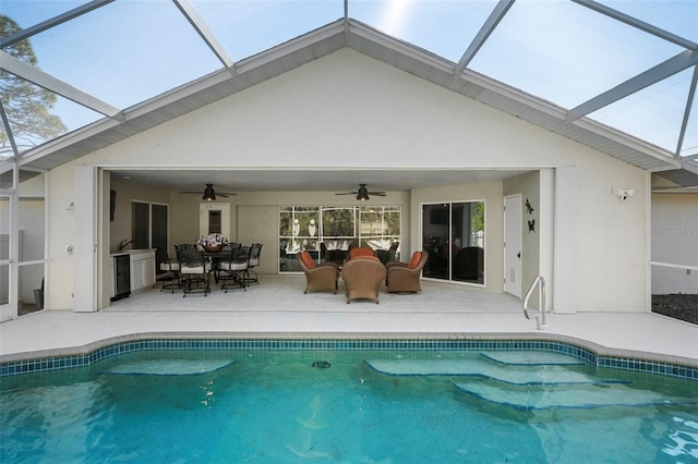 view of pool with a patio and ceiling fan