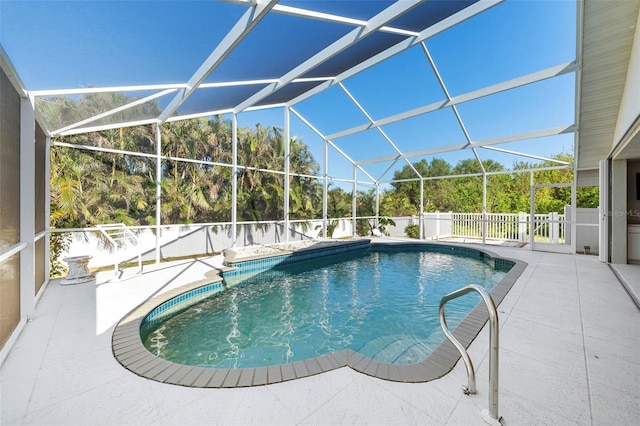 view of pool with a patio and a lanai