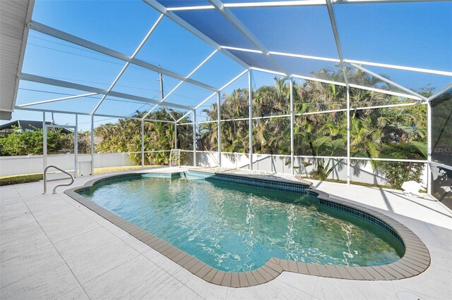 view of swimming pool with a patio and a lanai