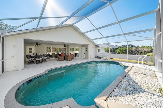 view of pool featuring a lanai, ceiling fan, a patio area, and an outdoor hangout area