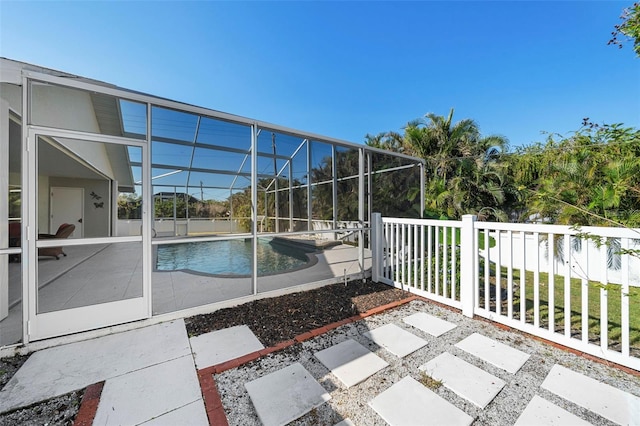 view of swimming pool with a lanai and a patio area