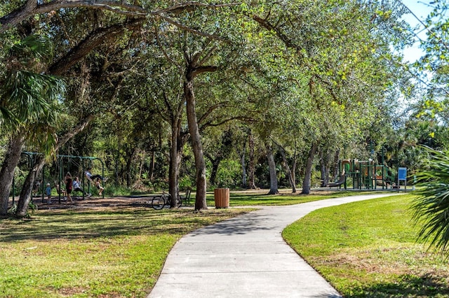 view of home's community featuring a yard and a playground