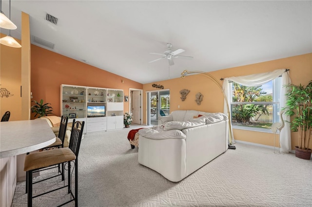 carpeted living room with plenty of natural light, lofted ceiling, and ceiling fan