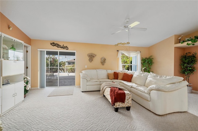 living room featuring a wealth of natural light, carpet floors, and ceiling fan