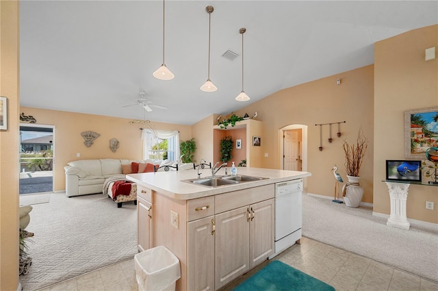 kitchen with a center island with sink, light brown cabinetry, sink, dishwasher, and lofted ceiling