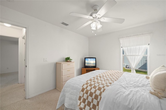 bedroom with ceiling fan and light carpet