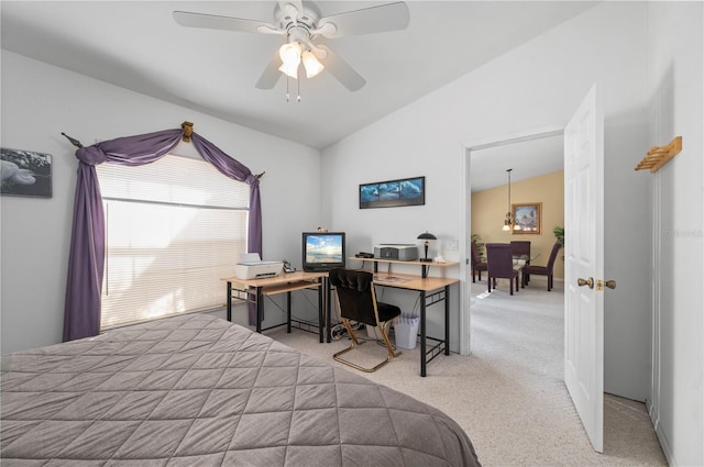 carpeted bedroom with ceiling fan and vaulted ceiling