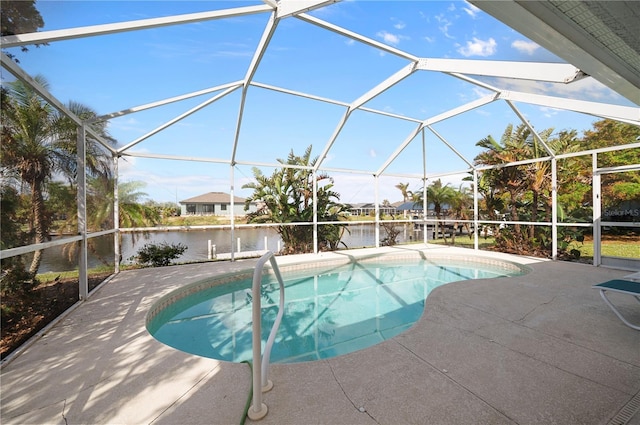 view of pool with a water view, glass enclosure, a patio, and a dock